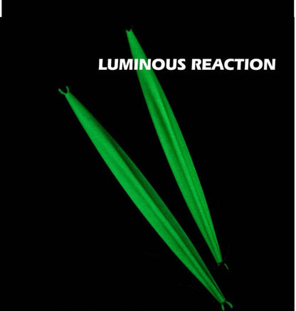  Luminous slow jigging lure shown on rocky shore before saltwater fishing trip 