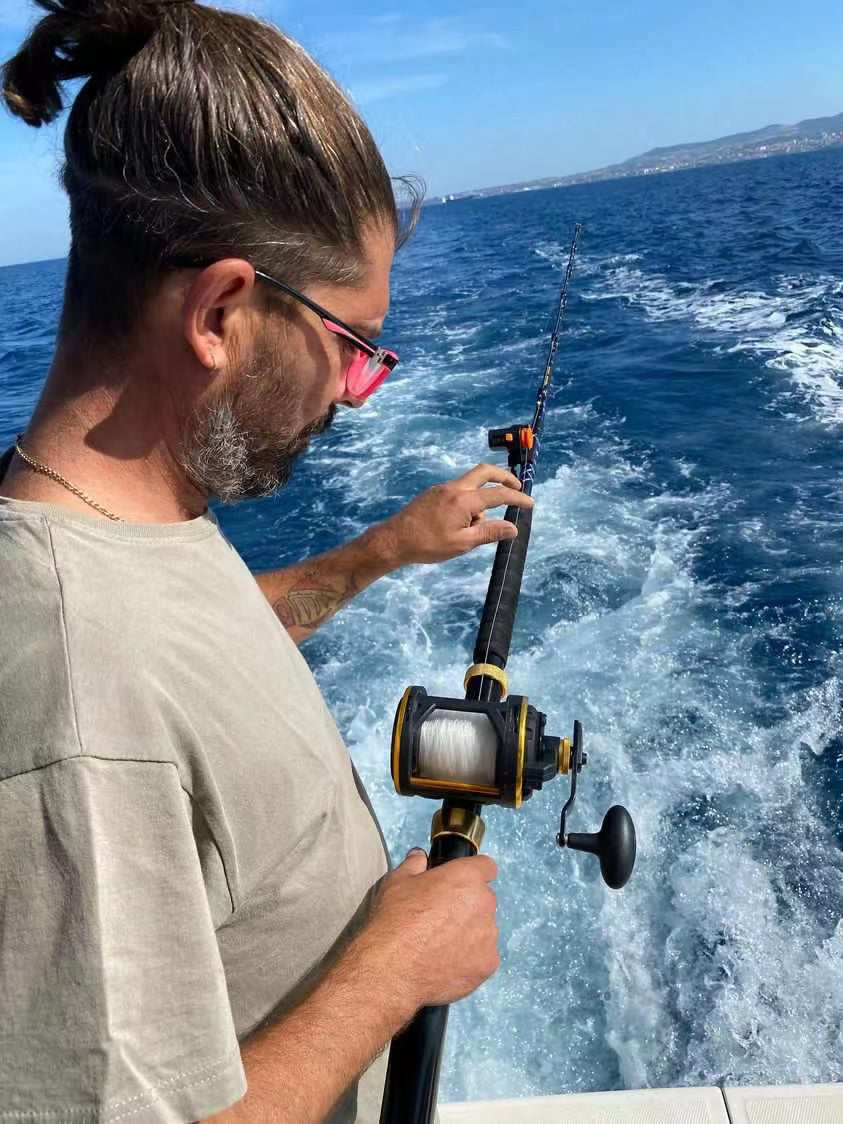 Topline trolling rod in use during an offshore fishing trip targeting large saltwater game.